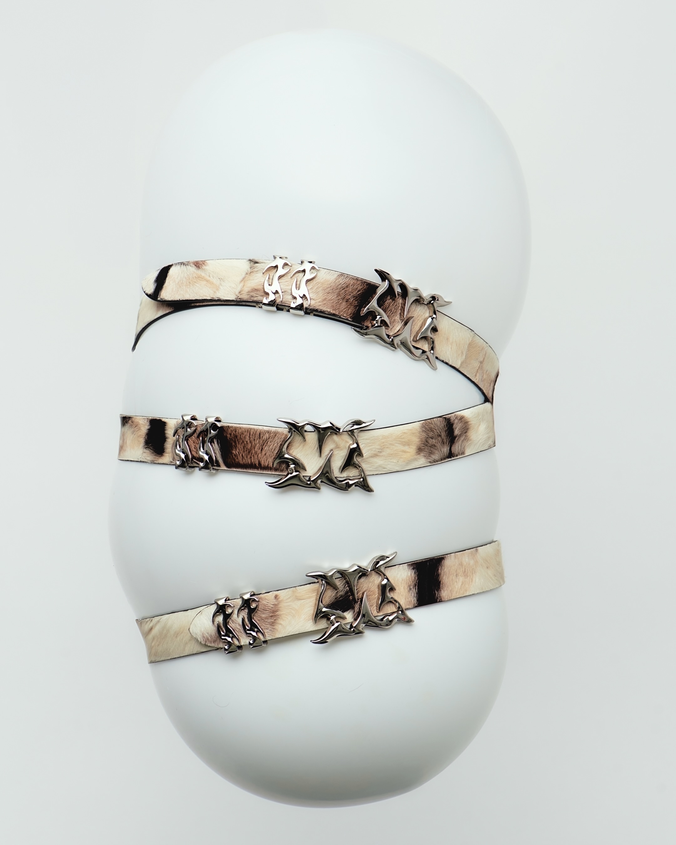 Vintage fur belts with sculptural steel buckles